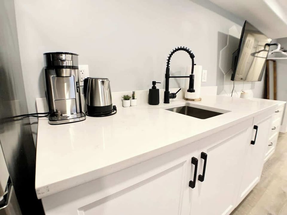 Side view of the kitchenette and its quartz countertop. Good working space and well equipped. We provide utensils, silverware, dining ware, etc. 