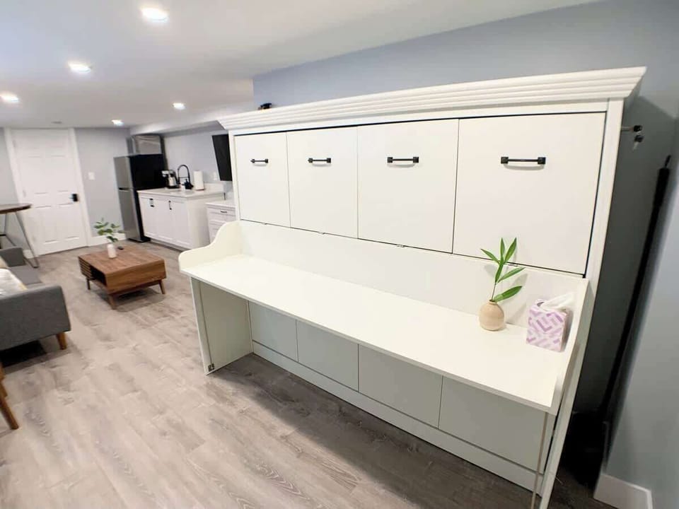 Close view of the Murphy bed closed and used as a desk. Ample space for working area. 