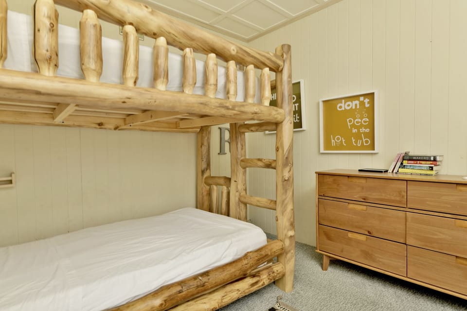 Peaceful cabin bedroom with plush bedding, and beautiful views—ideal for restful nights, cozy mornings, and a relaxing mountain escape.