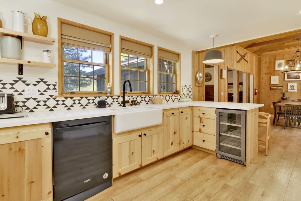Fully equipped cabin kitchen with ample cabinetry, stove, fridge, microwave, and coffee maker—perfect for cooking meals, morning coffee, and feeling right at home on your stay.