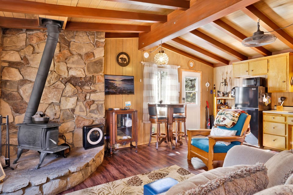Sunlit seating area with cozy accents and open flow to dining.