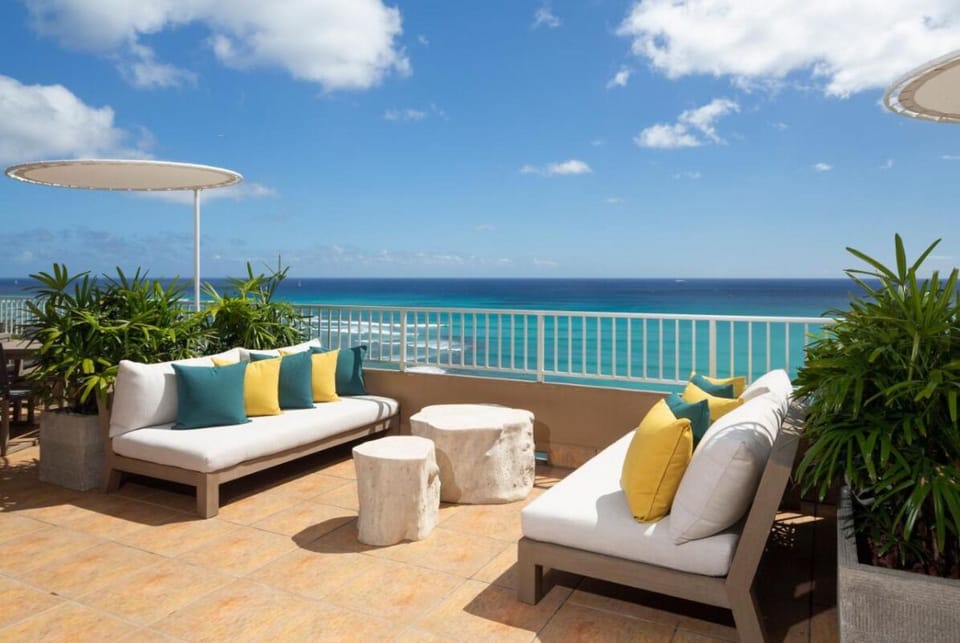 Unwind on plush loungers with endless oceanfront blue views.