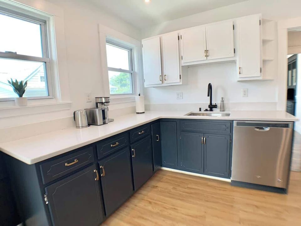 Kitchen:  Working area view showing a combination of black fixtures and brass handles. 