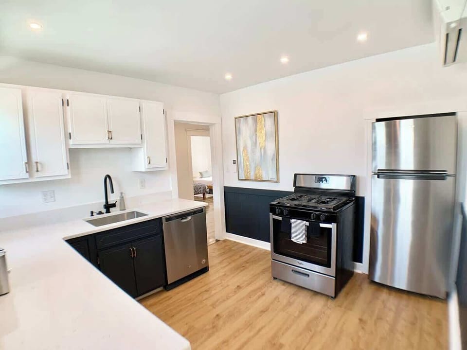 Kitchen: Corner shot showing access to the rooms and view to all stainless steel appliances. 