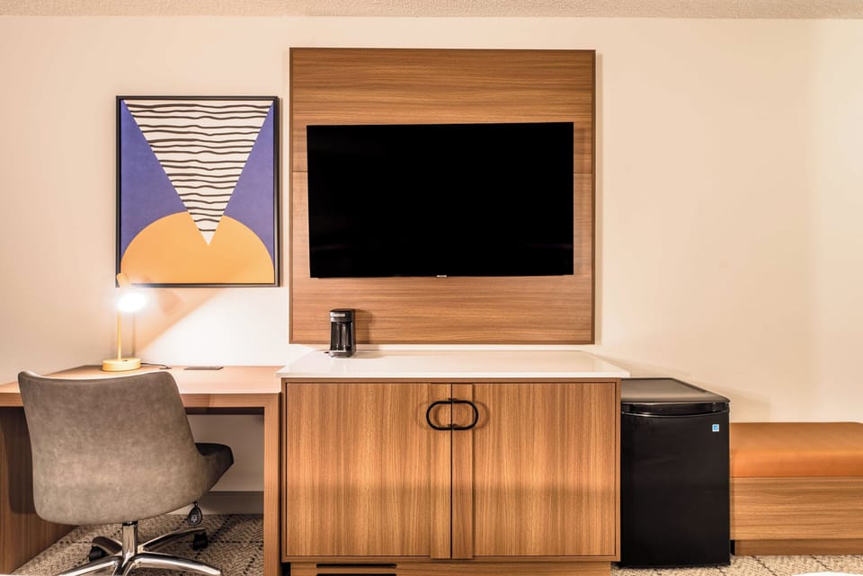 Settle in to work comfortably with desk, TV, and fridge.