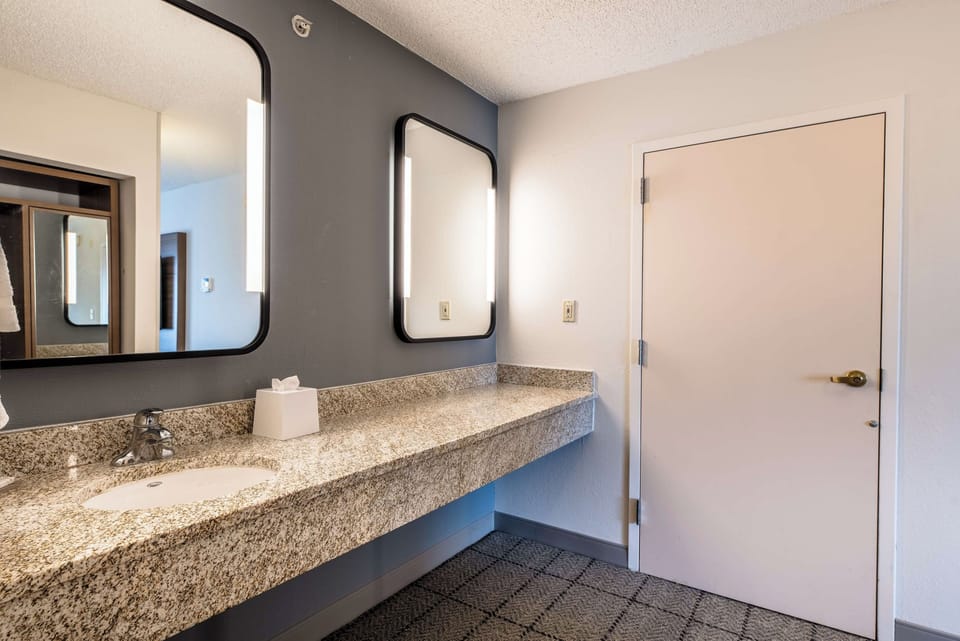 Refresh comfortably at the spacious vanity with bright lighting.