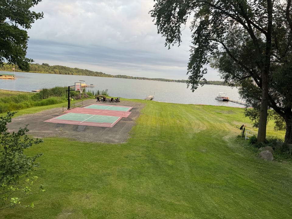 150’ of shore line, private pickleball court, basketball court. Large fire pit.