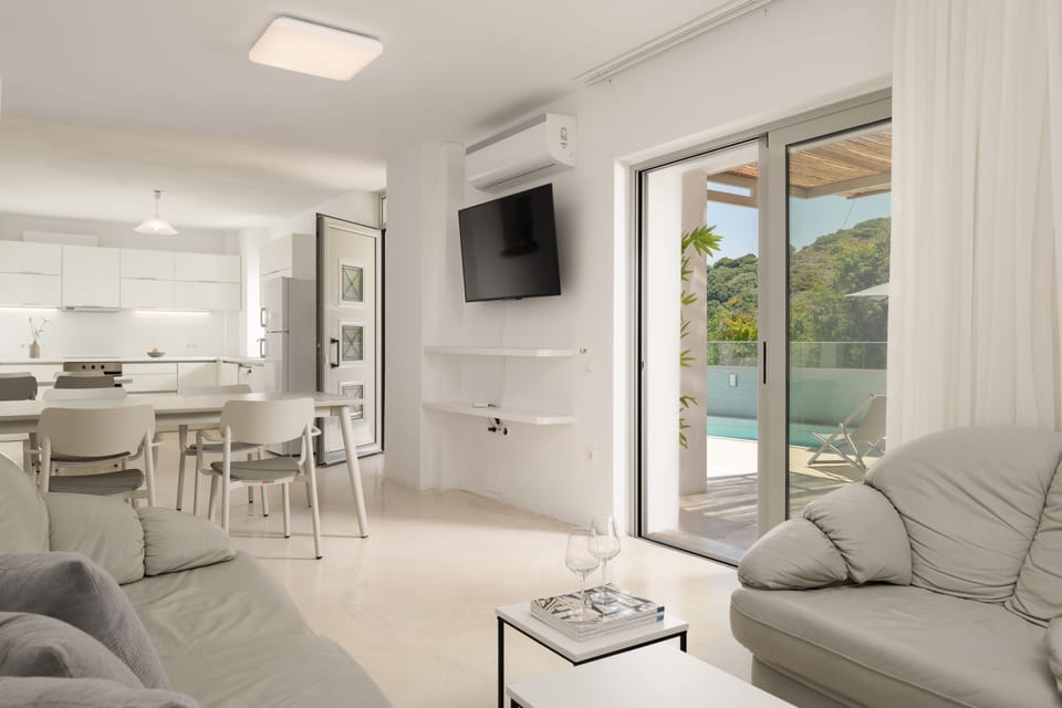 Living room and dining settings featuring a flat screen TV.