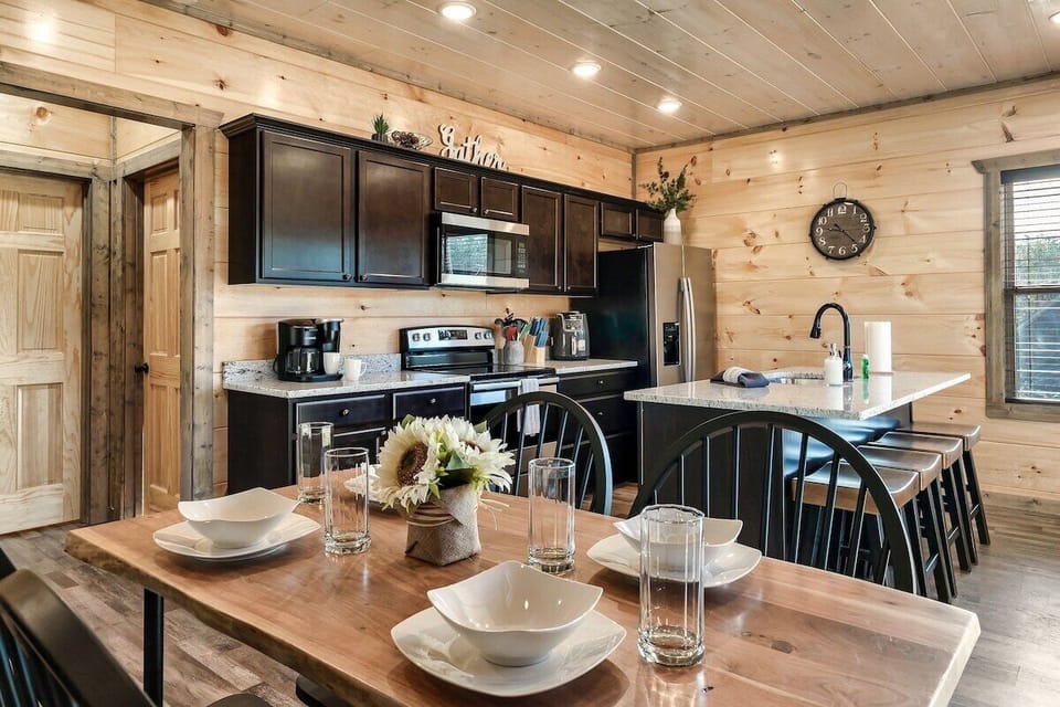 Open concept kitchen, island, and dining table.