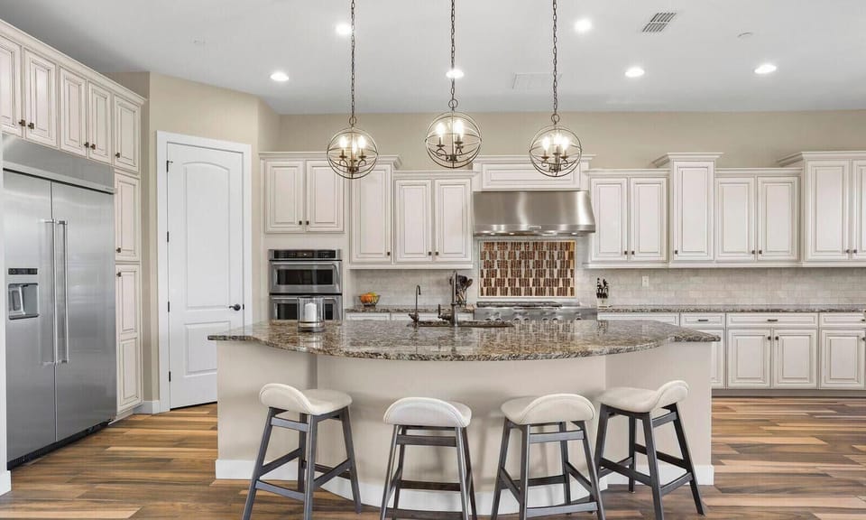 Kitchen island w/ large fridge, gas range and dual stove/convection oven/micro
