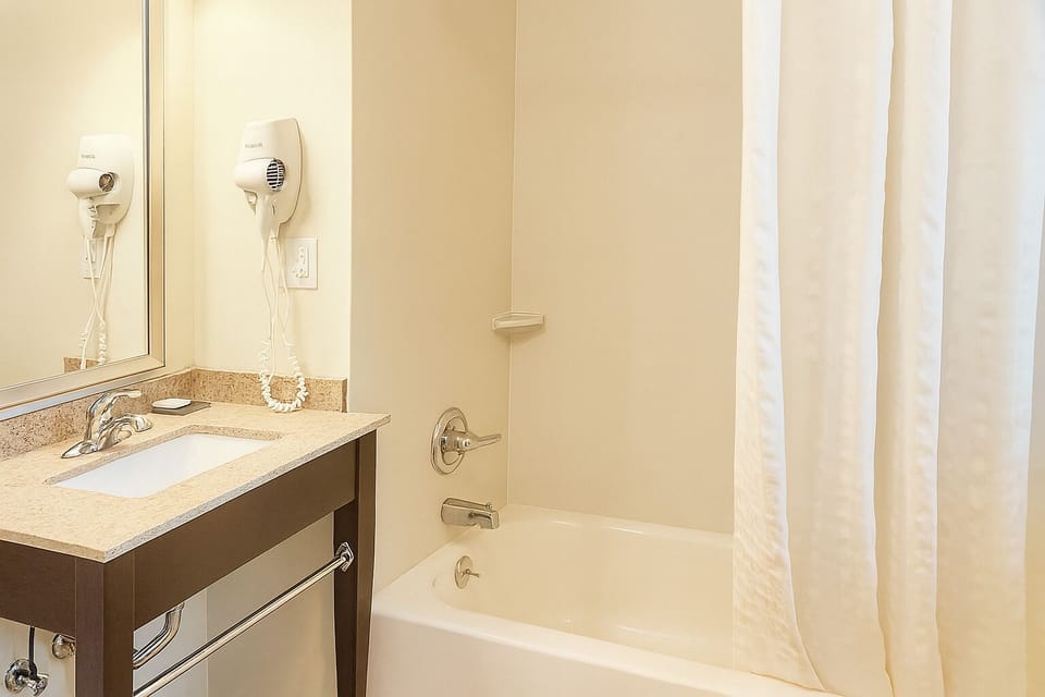 Refresh with a bright vanity and relaxing shower-tub combo.