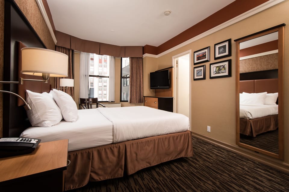 Recharge in a calm king space with warm, relaxing lighting.