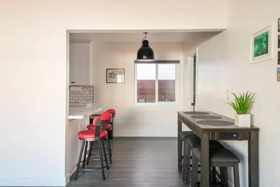 Granite bar countertop with leather bar stools & a beautiful wood table.