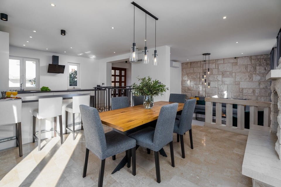 A spacious dining area, and a living room with a flat-screen TV .