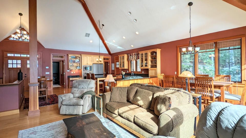 Living room offers large windows overlooking the lake