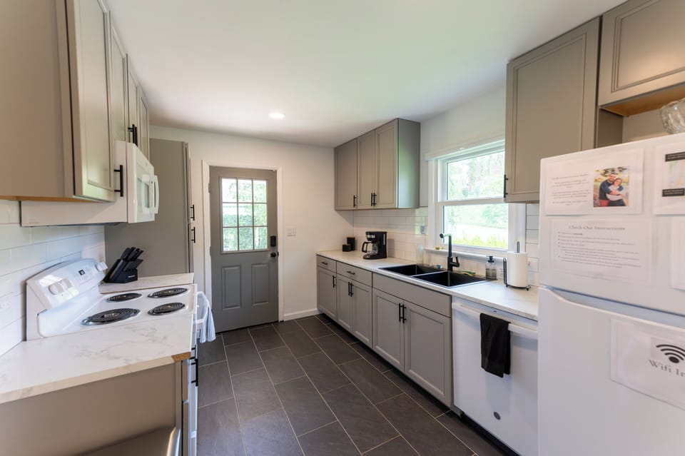 The kitchen features all new appliances, cabinets, and tile as of Fall '22.