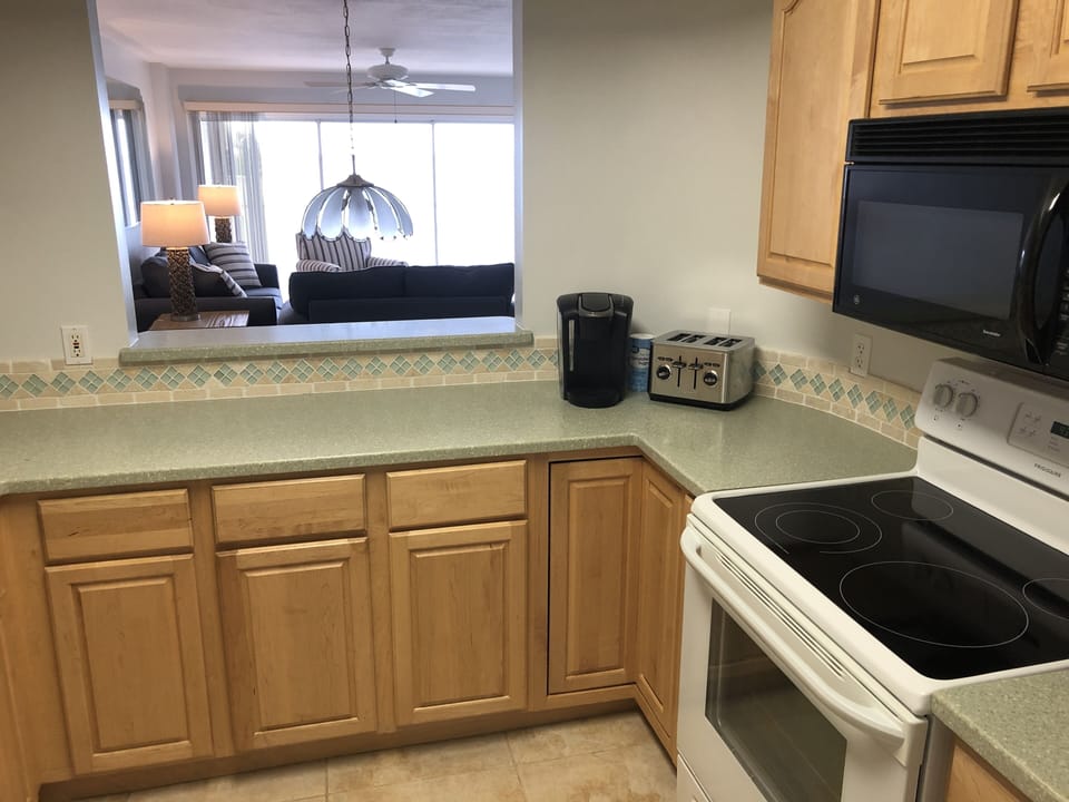 Kitchen oven, microwave, 4-slice toaster, coffee maker and Kuerig. 