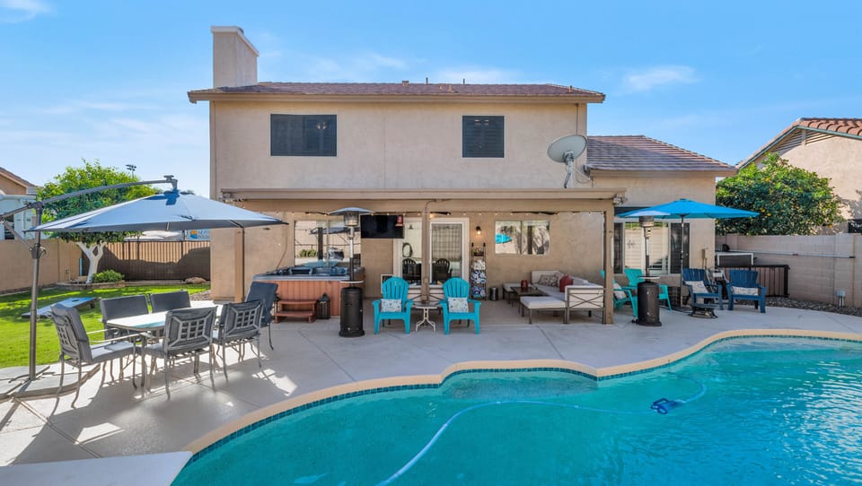 Spacious backyard with heated pool, hot tub, fire pit, BBQ, and more.