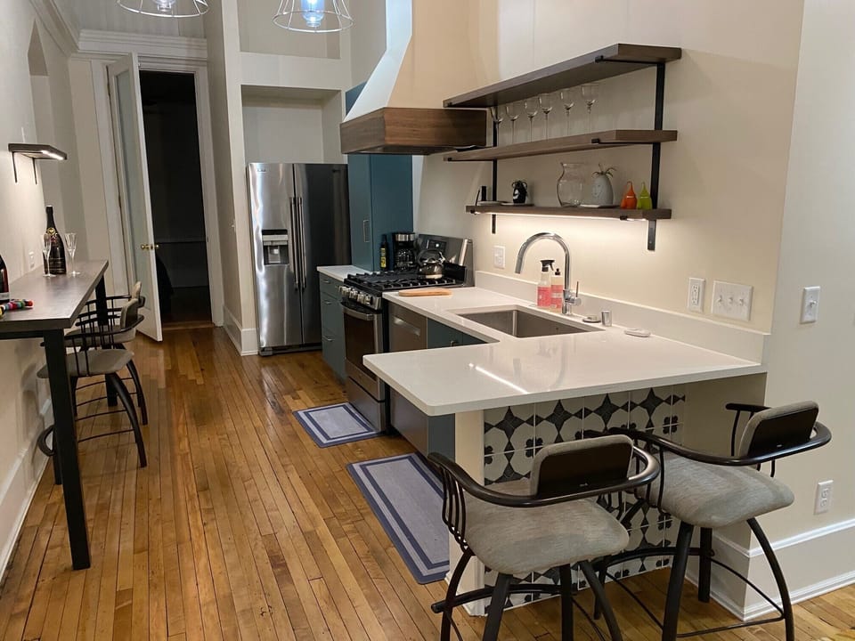 Kitchen with counter and coffee bar for seating and working.