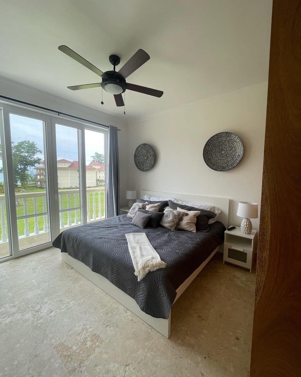 Primary bedroom with kind bed overlooking ocean
