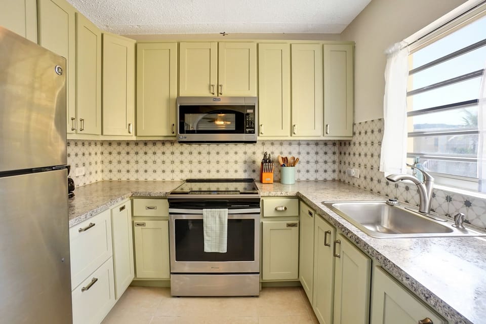 Kitchen with full-size appliances, coffee makers, a blender, utensils, etc.