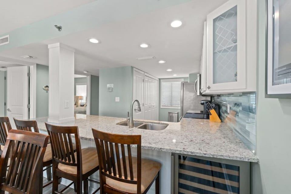 Gorgeous updated kitchen. Granite counters, stainless steel appliances, & fully-stocked for your stay. Breakfast bar seats 4. Utilize the wine fridge!