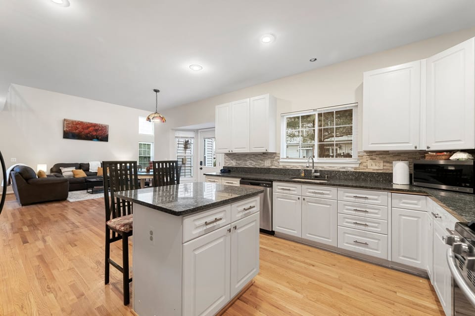 Beautiful kitchen having center slab with two dedicated chairs.