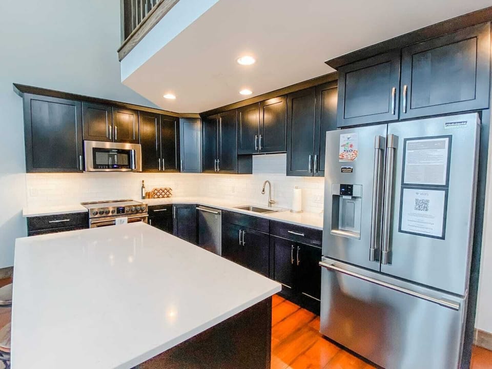 The kitchen boasts modern appliances, ample counter space, and all the cookware and utensils you need to whip up delicious meals. The open design allows for easy conversation and interaction between the chef and guests. There are 3 seats at the islan