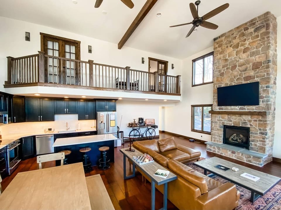 The main gathering area, designed to feel "togetherness" while also having room to have separate activities and conversations. This room has a cozy gas fireplace, a full kitchen and dining room area. Plenty of seats for everyone. 
