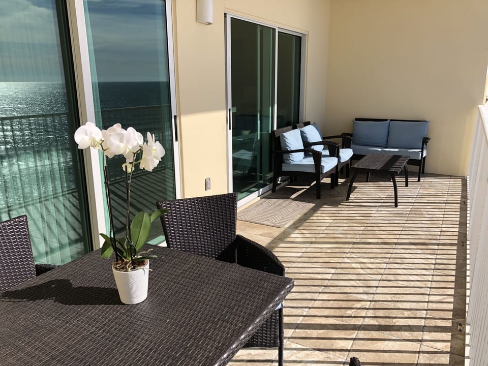 Large tiled balcony with plenty of seating for taking in the gulf views.