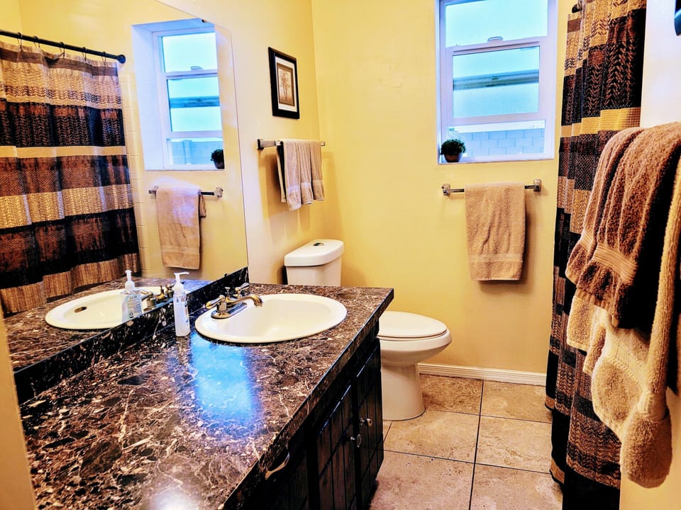 Hall bath with shower over bathtub 
