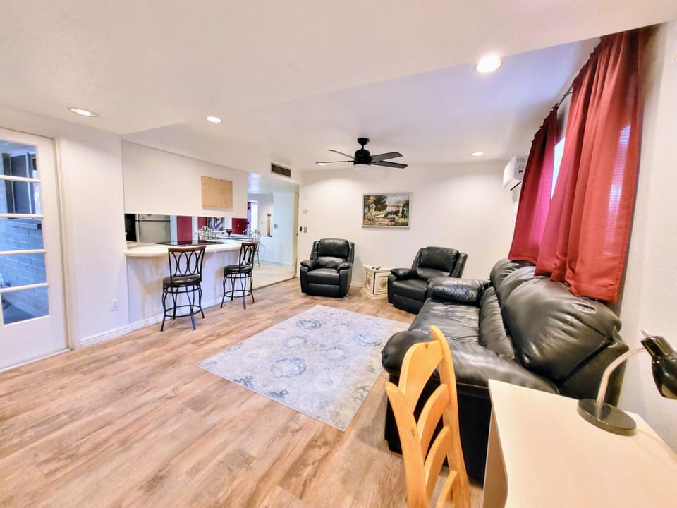 Family room with couch,  arm chairs,  and desk
