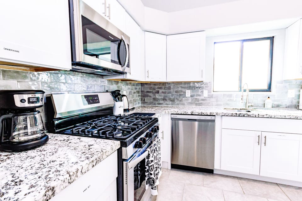 Modern kitchen is fully stocked and furnished with stainless steel appliance 