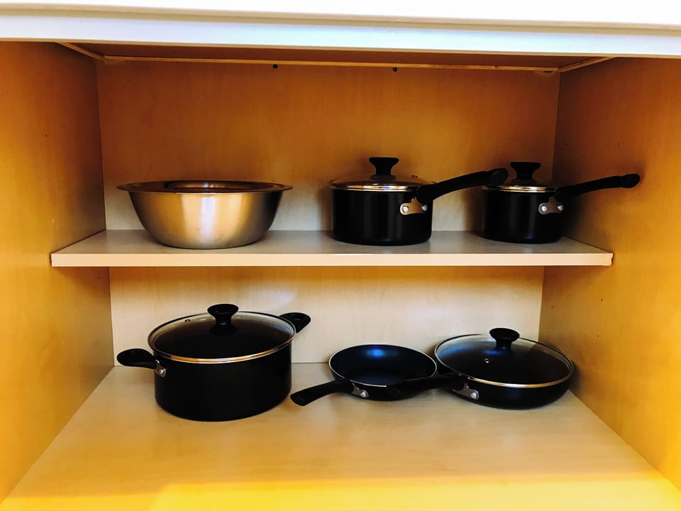 Fully stocked with all the kitchen gears stored in the cabinets