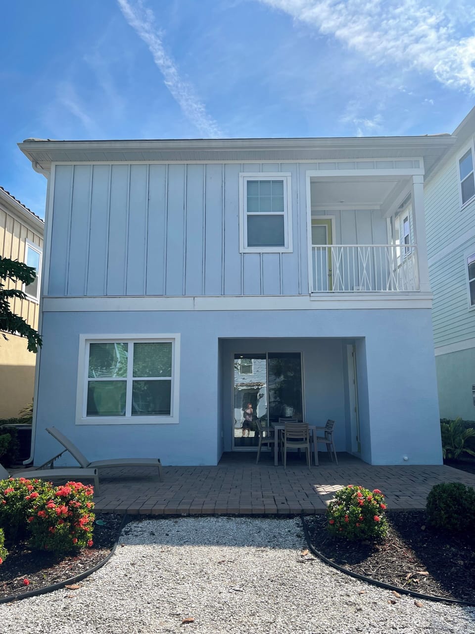 back of house with private balcony off master