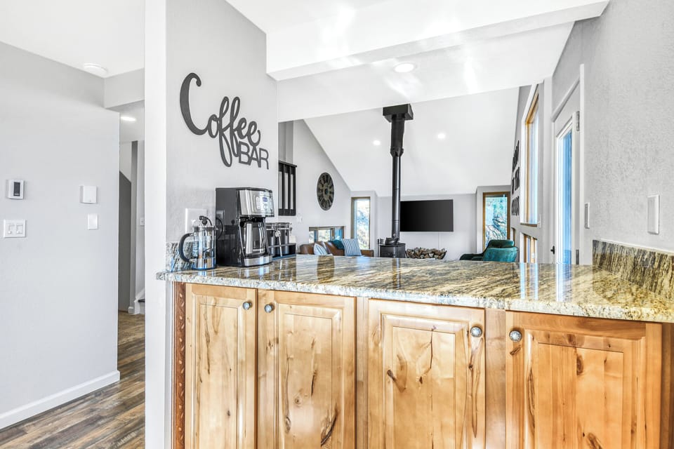 Fully stocked coffee bar with coffee, creamer packets, flavored syrups and sugar