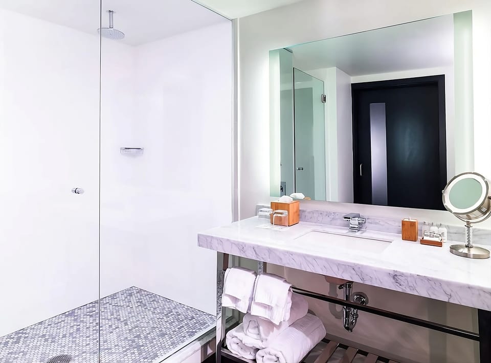 Refresh in a spa-clean bath with rainfall-style glass shower.