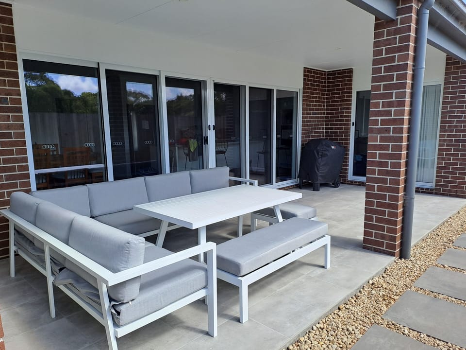 Covered alfresco with lounge setting and Weber BBQ