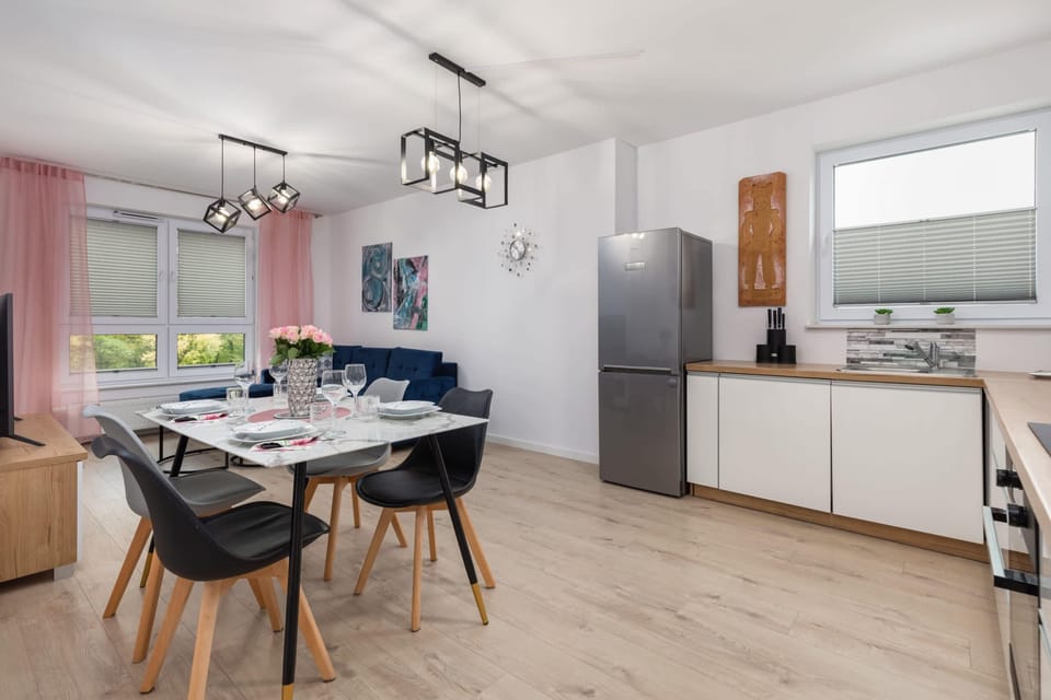 A wide view of the dining and kitchen area, emphasizing its spacious and modern design.
