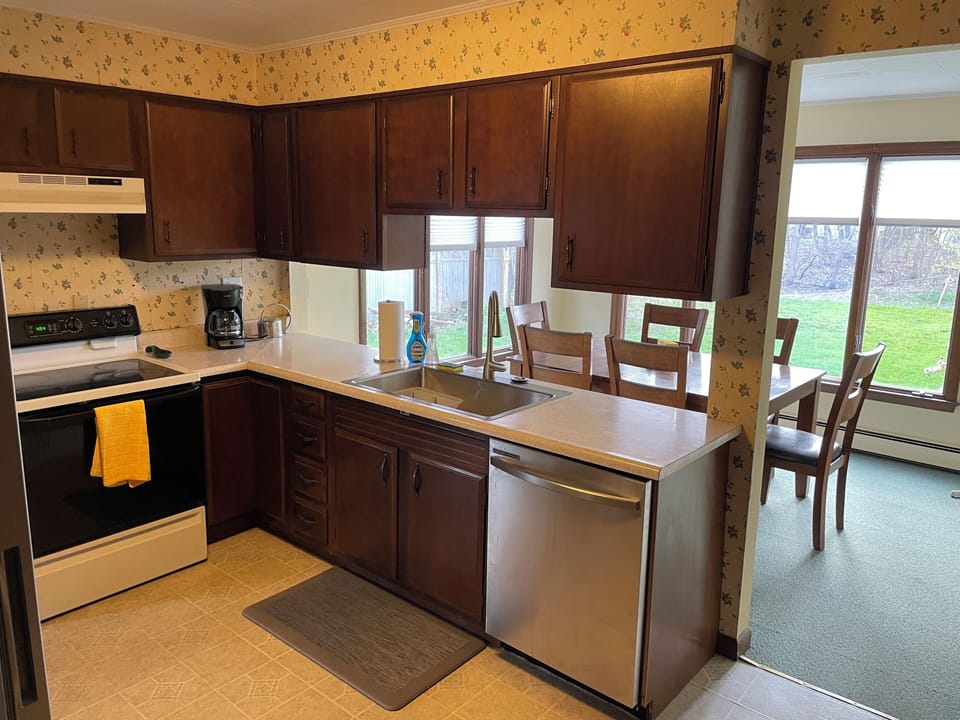 Clean, efficiently laid out kitchen with large single-basin sink and dishwasher.