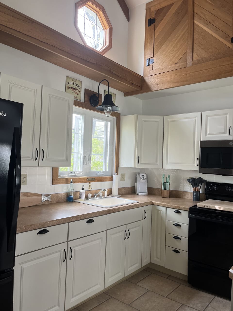 Kitchen with Keurig, toaster, microwave, coffee maker, refrigerator, ice maker