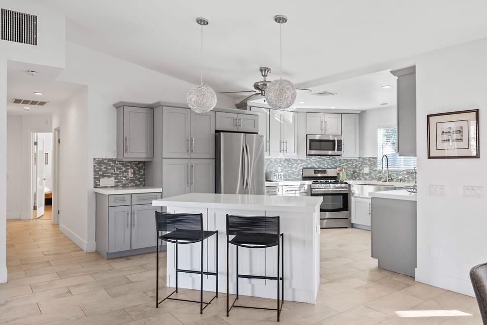 Updated kitchen with gas range and wine fridge.