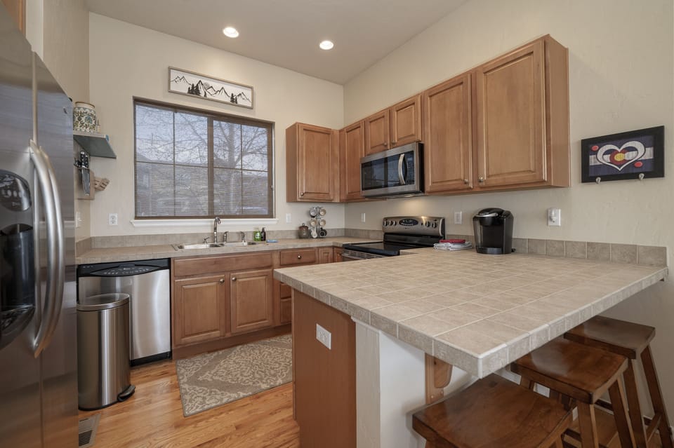 - Fully equipped kitchen with stainless steel appliances   - Spacious counters make meal prep easy and enjoyable   - Includes dishwasher and microwave for guest convenience