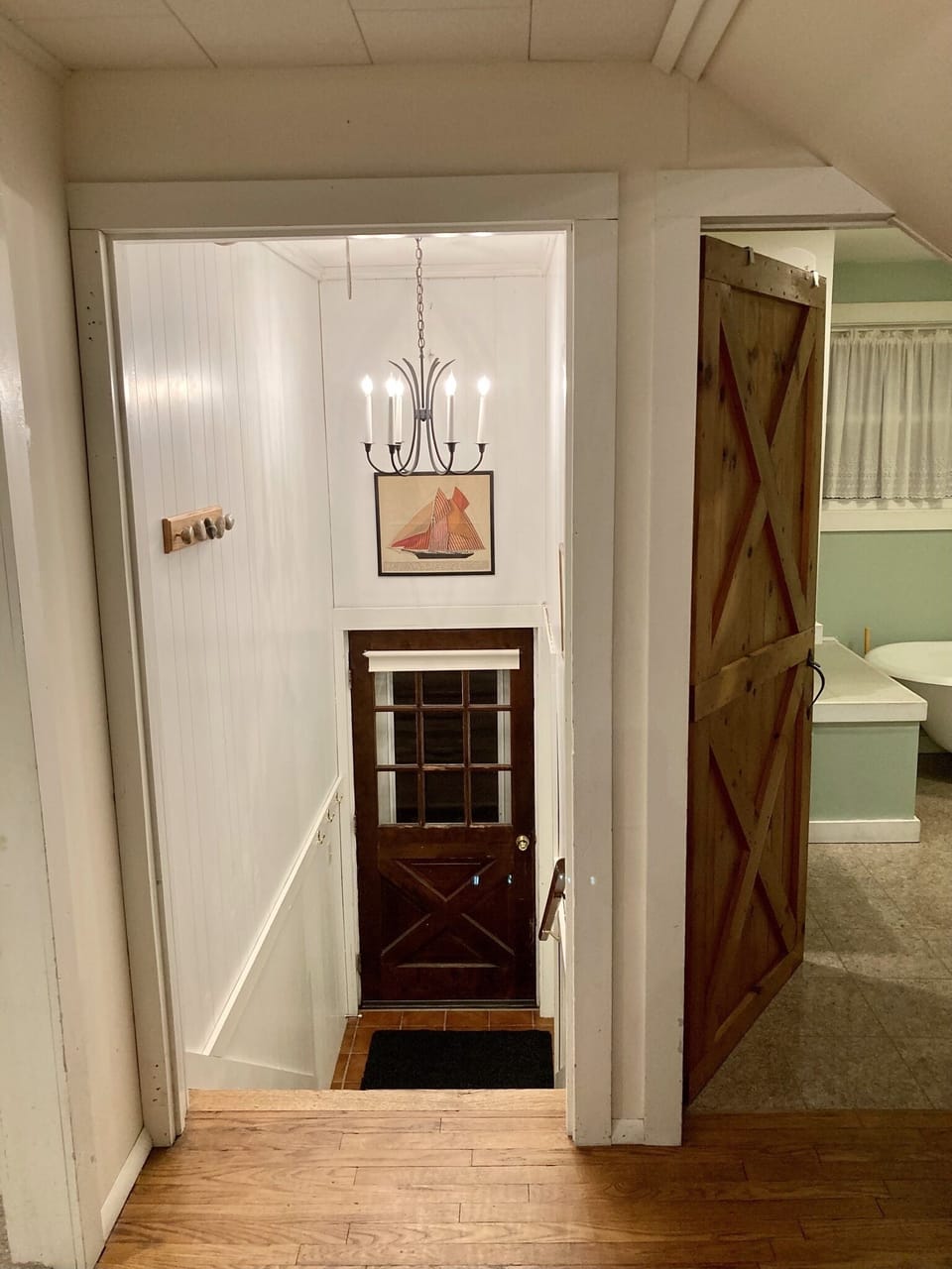 View from main entry hall, front door on the left and main bathroom on right 