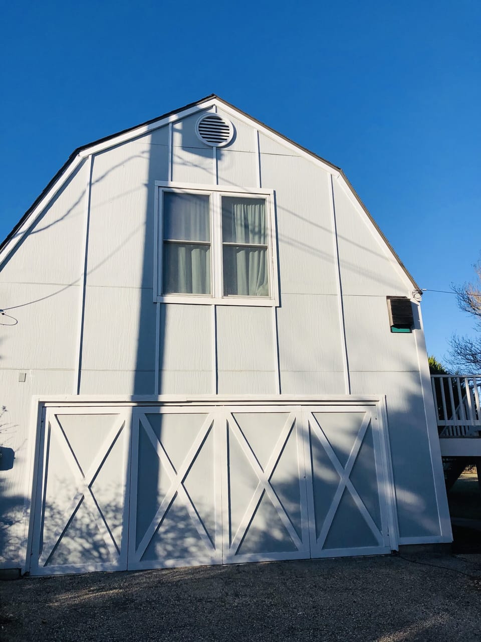 Front side of the blue barn with your parking spot right in front of it
