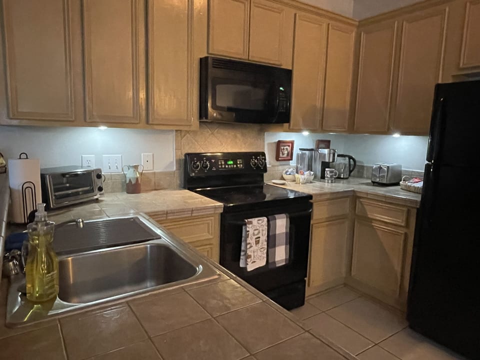 Full kitchen with essential cooking pans and baking tools 