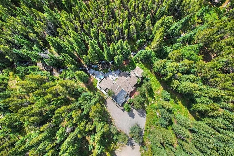 With towering 100' Lodge Pole Pines. Secluded in a private cul-de-sac and adjacent to acres of national forest, the chateau serves as your gateway to world-class hiking and the untouched beauty of the wilderness.