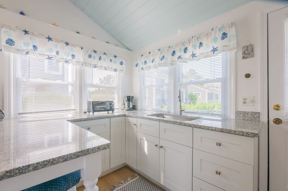 Updated white kitchen with granite countertops.