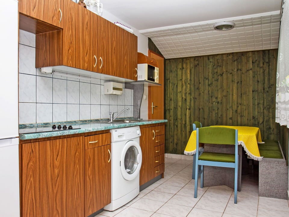 Cabinetry, Property, Furniture, Building, Countertop, Kitchen Stove, Kitchen Appliance, Laundry Room, Wood, Kitchen