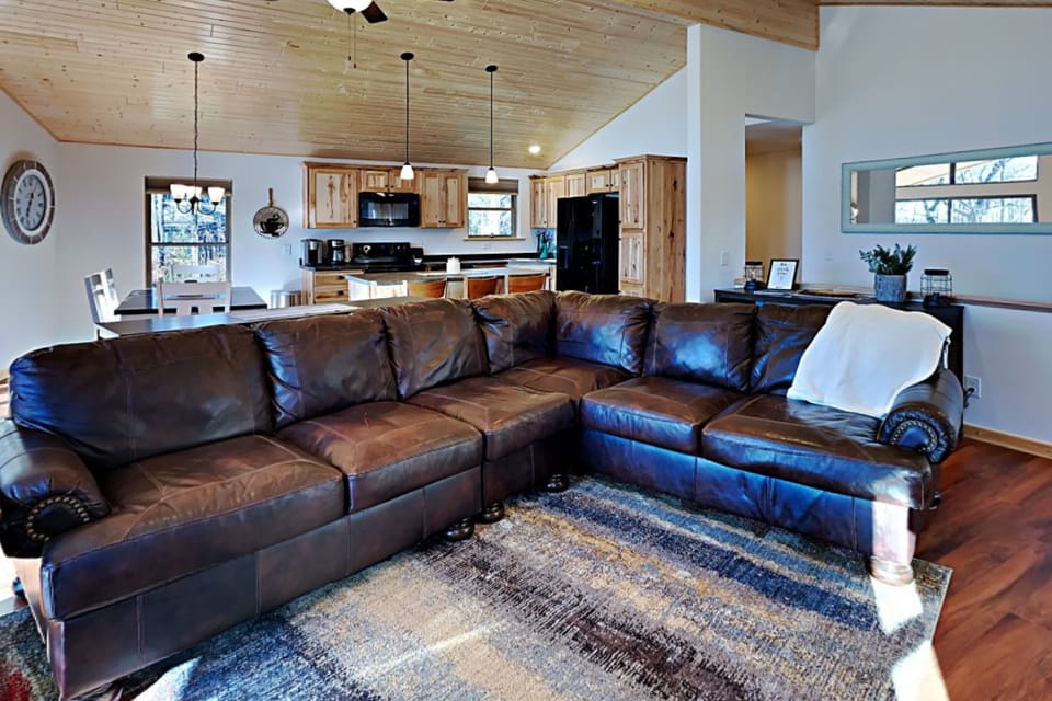 Sink into this ultra comfortable couch and warm yourself by the fireplace as you gaze at the lake below